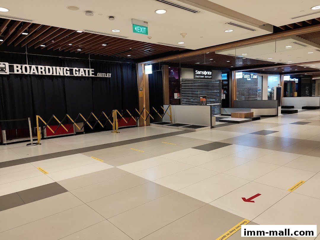 The entrance to 'Boarding Gate Outlet' and other shops like Samsonite and Vinter Time in a mall.