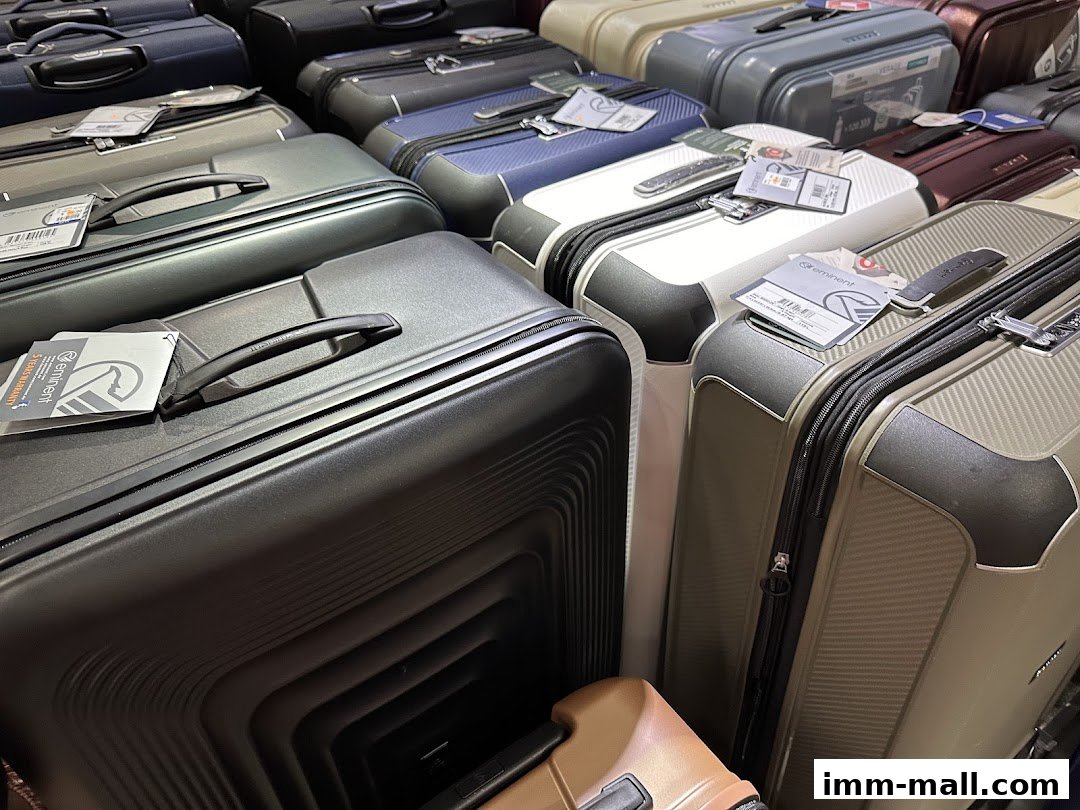 A close-up view of various stylish and durable suitcases in different colors and sizes.