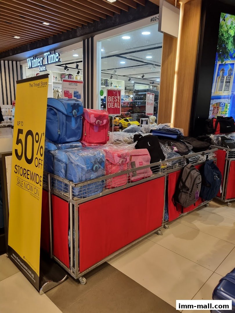 The Travel Store shop front with a sale banner and display of bags.