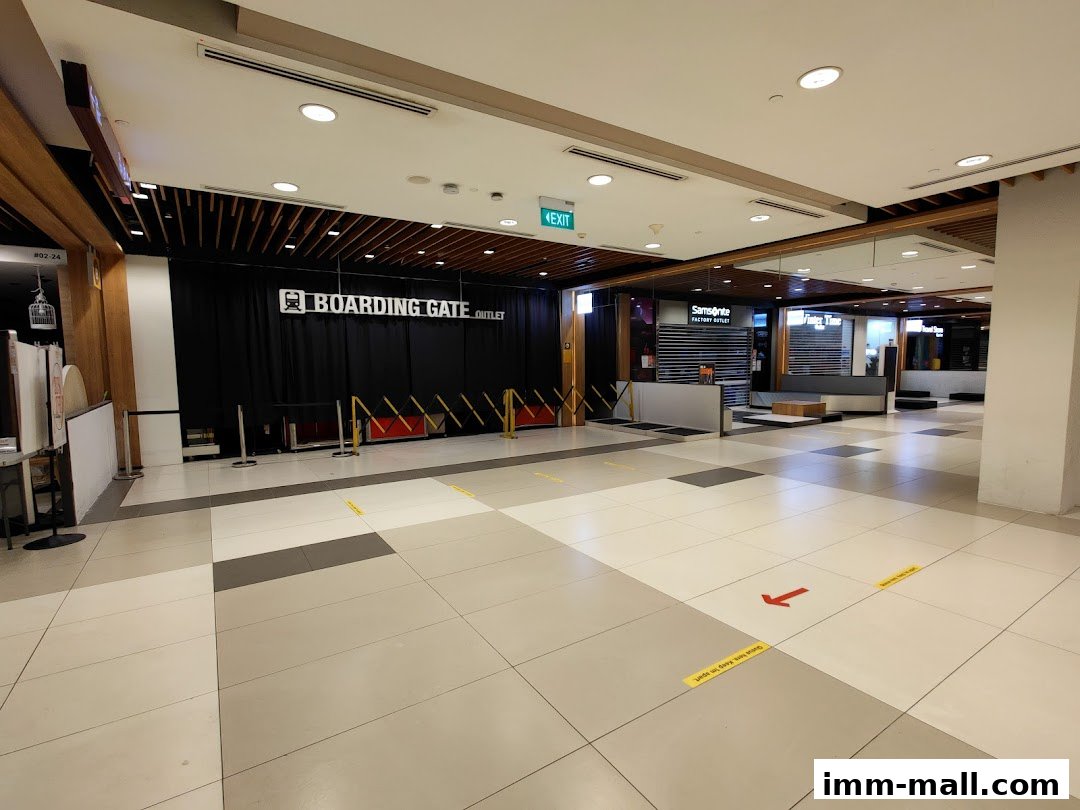 The entrance to 'Boarding Gate Outlet' and 'Samsonite Factory Outlet' shops in a mall.