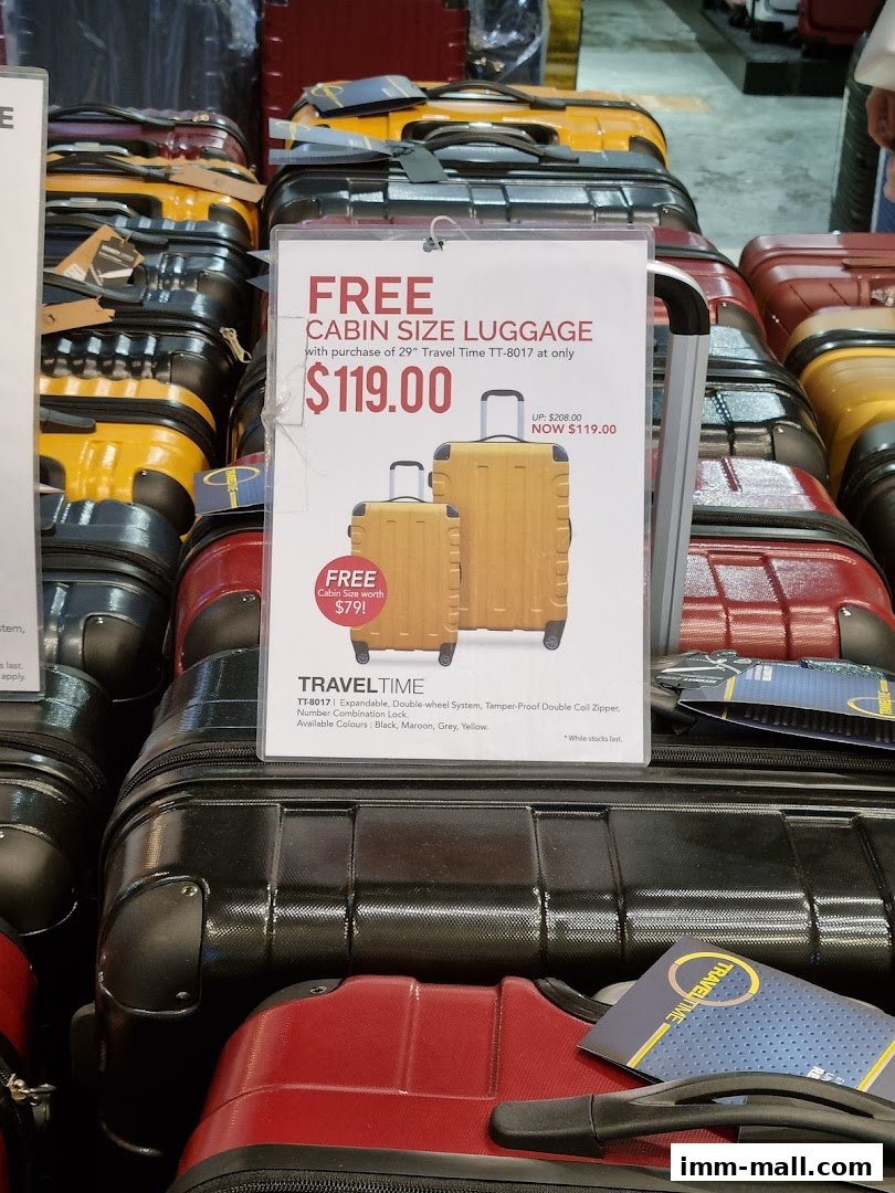 A sign advertises free cabin size luggage with the purchase of a 29" Travel Time suitcase.