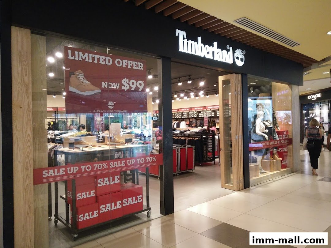 Timberland store front with sale signs and displays of shoes and apparel.