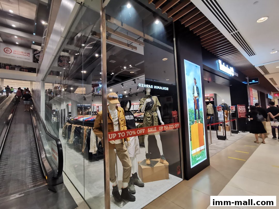 Timberland store entrance with mannequins displaying clothing and a sale sign.