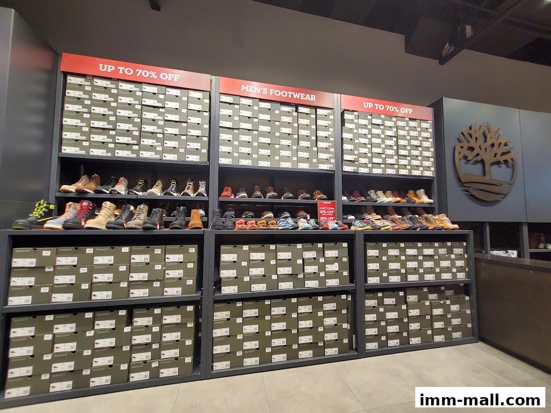 Timberland store interior showcasing shelves of footwear and stacked shoe boxes with sale signs.