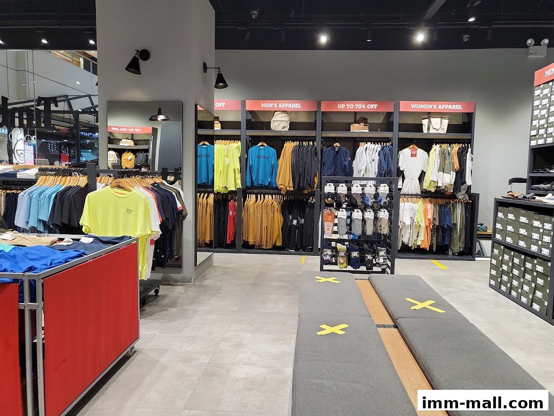 Interior view of a Timberland store showcasing apparel and footwear with sale signage.