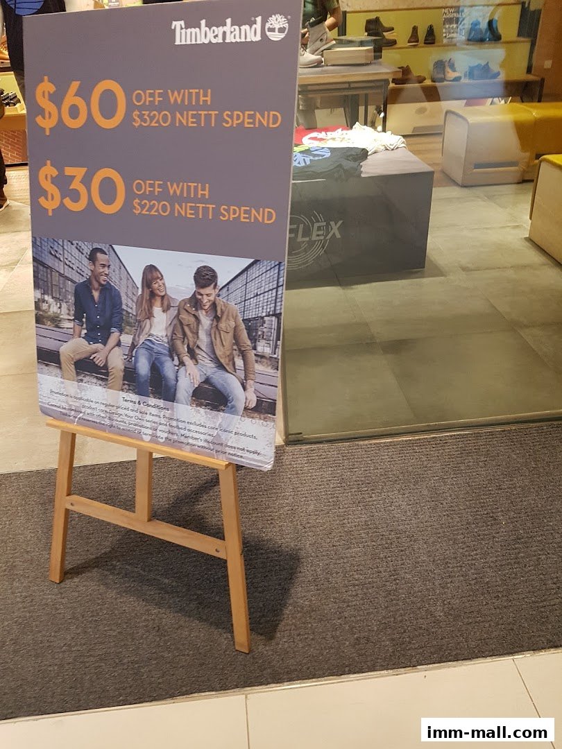 A Timberland store sign advertising discounts with minimum spend.