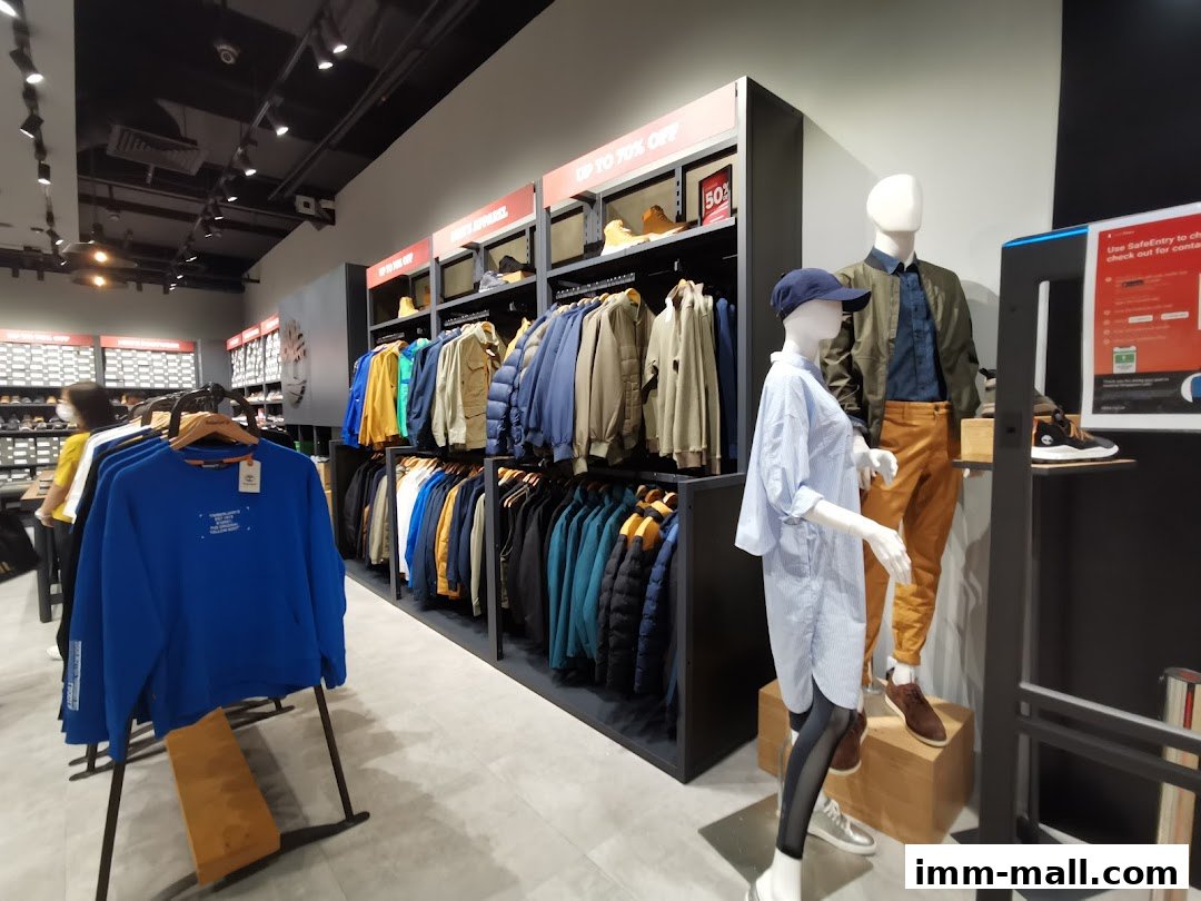 Interior of a Timberland store with clothing racks, mannequins, and sale signage.