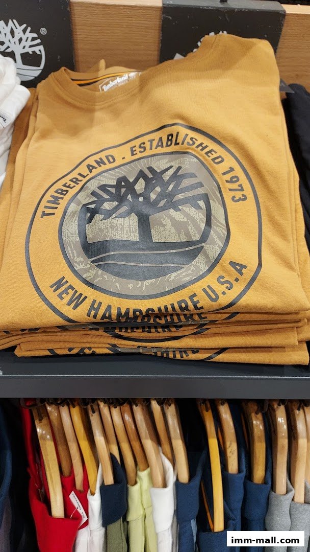 A stack of yellow Timberland t-shirts with a circular logo and text.
