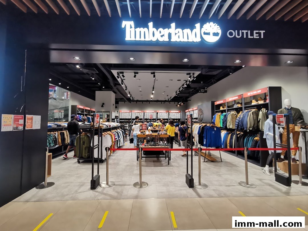 The entrance to a Timberland Outlet store, showcasing clothing and footwear displays.