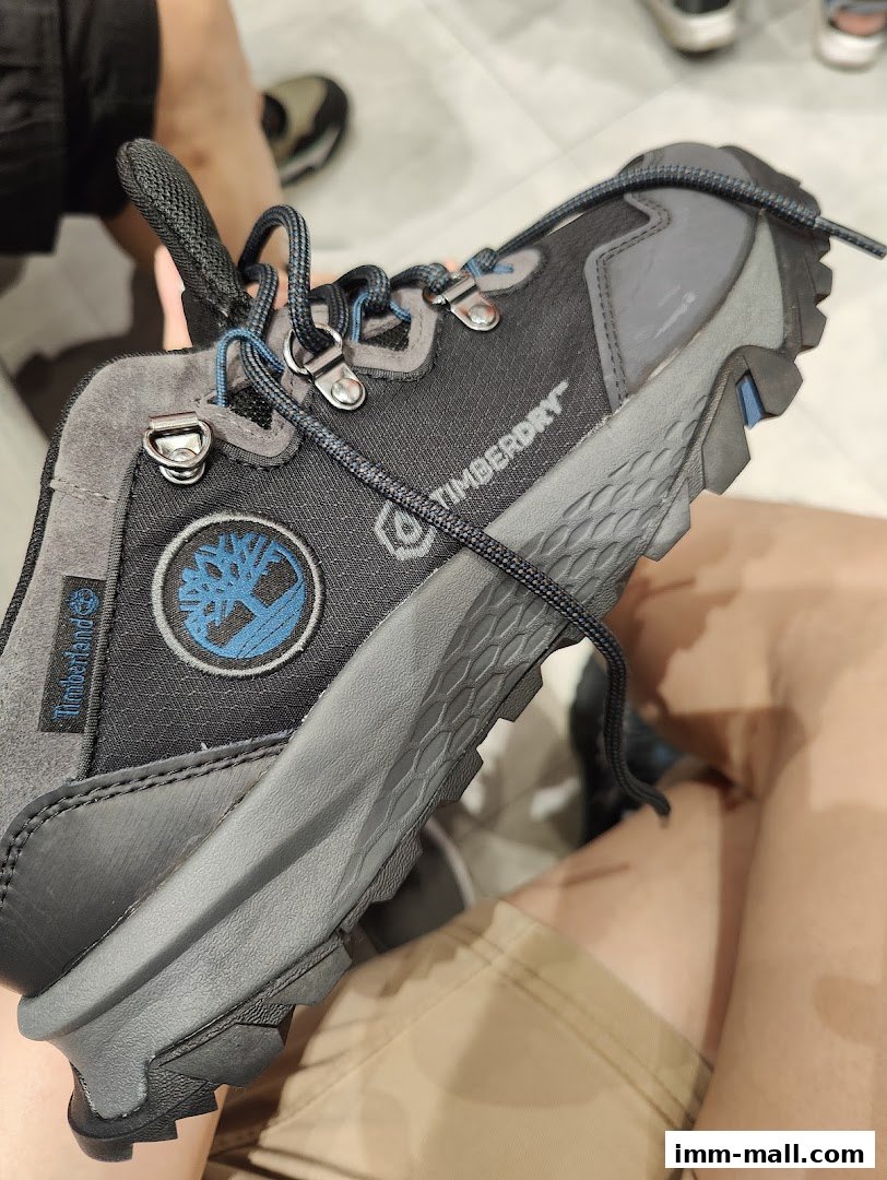 A close-up view of a Timberland hiking boot with laces and the brand logo.