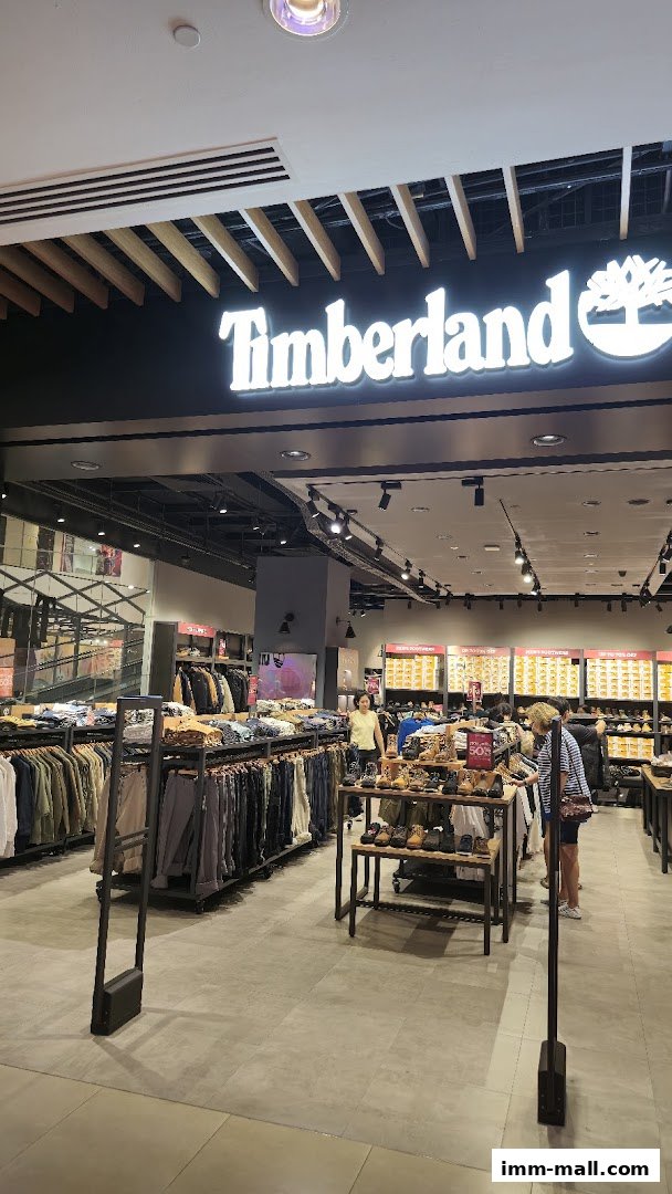 Interior view of a Timberland store showcasing clothing and footwear displays.