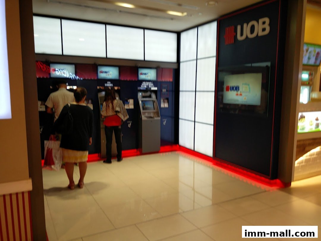 People using UOB ATMs in a brightly lit area with modern signage.