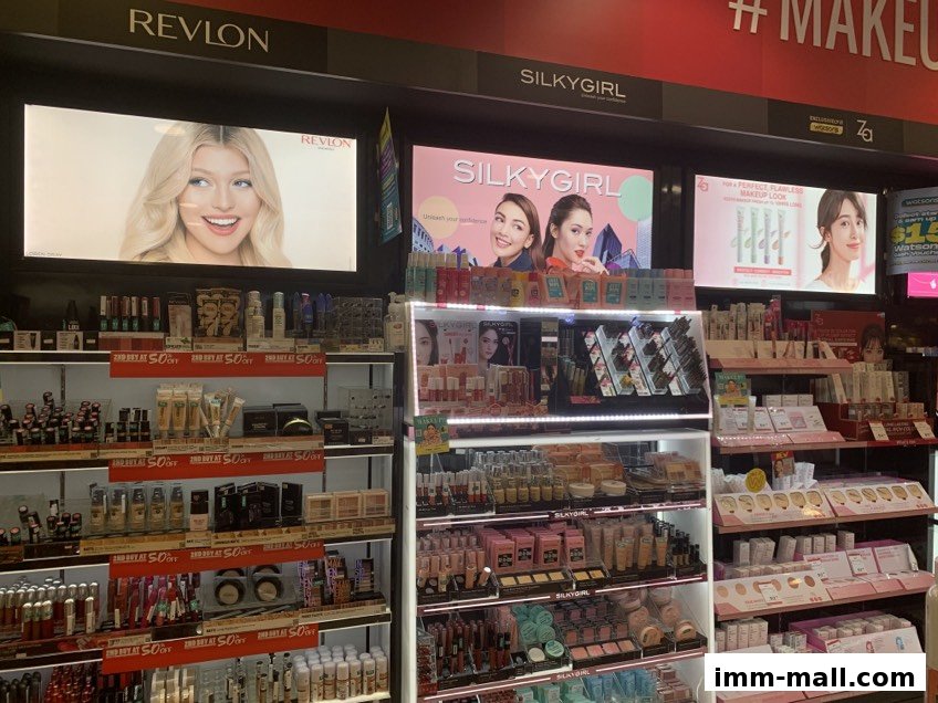 A wide selection of makeup and beauty products from brands like Revlon and Silkygirl on display.
