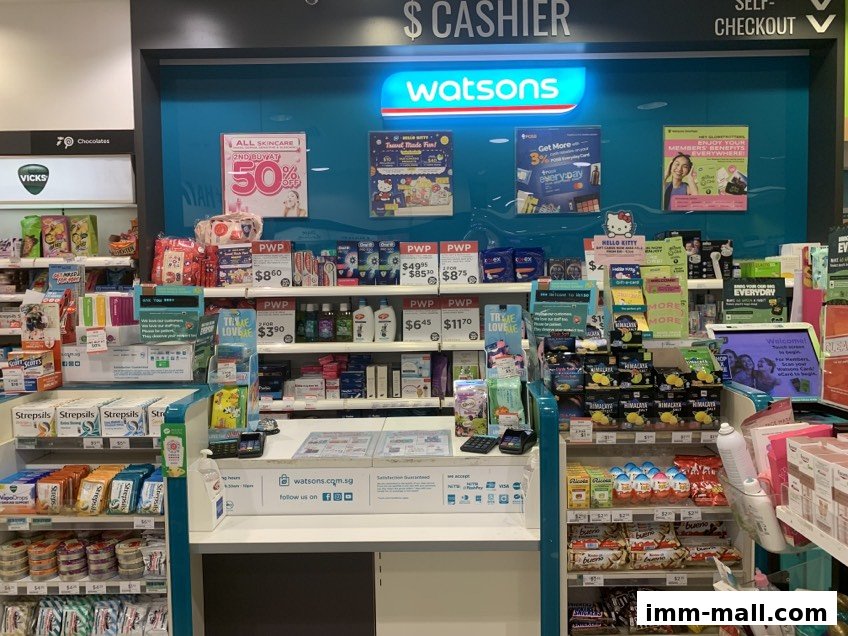 Interior view of a Watsons store with a cashier counter and shelves stocked with health and beauty products.