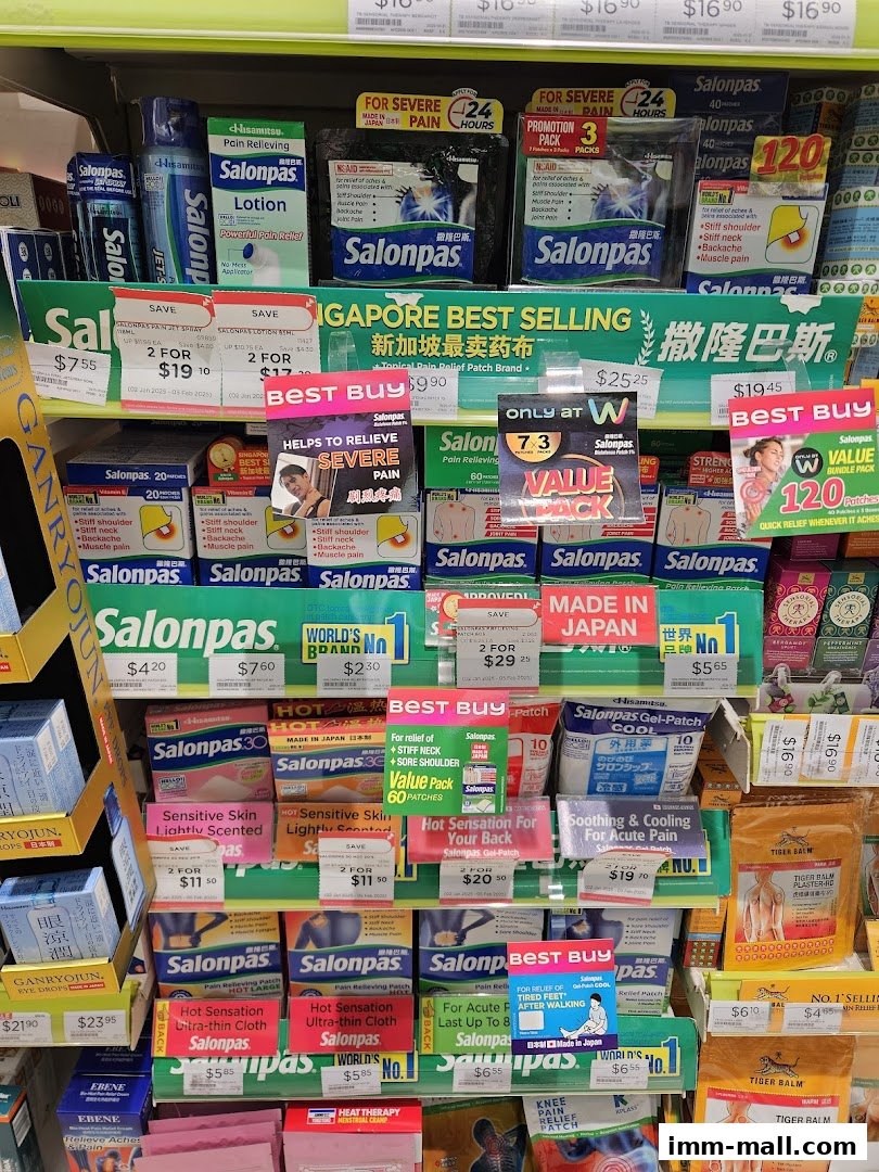 A display of various Salonpas pain relief patches and other health products on shelves.