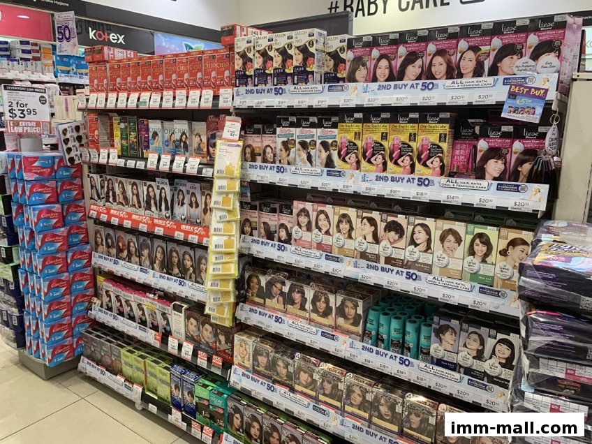 Shelves stocked with hair dye products and personal care items in a retail store.