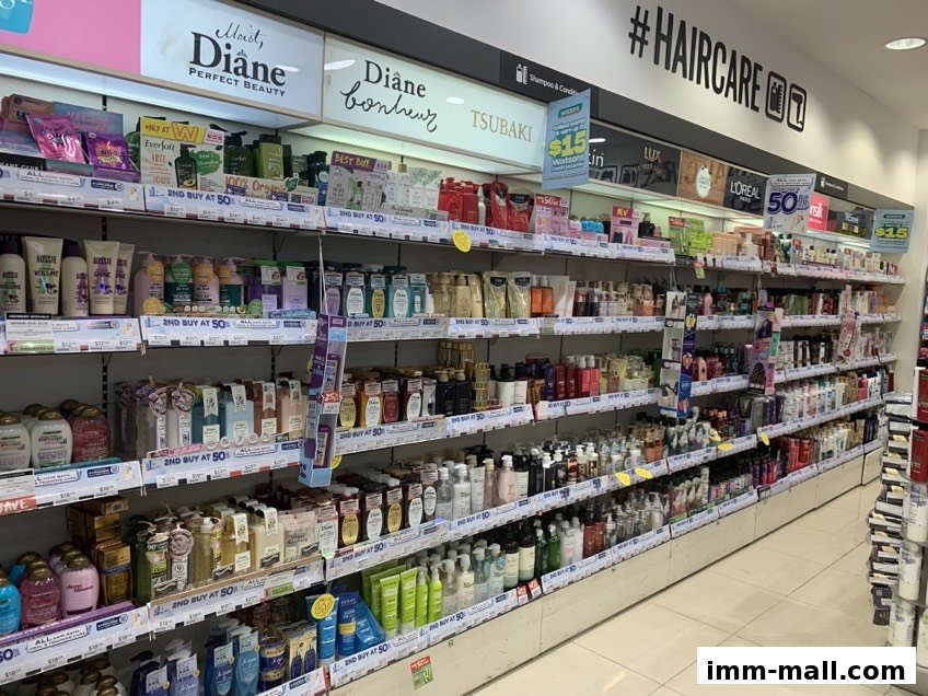 Shelves stocked with a wide variety of haircare products, including shampoos and conditioners.