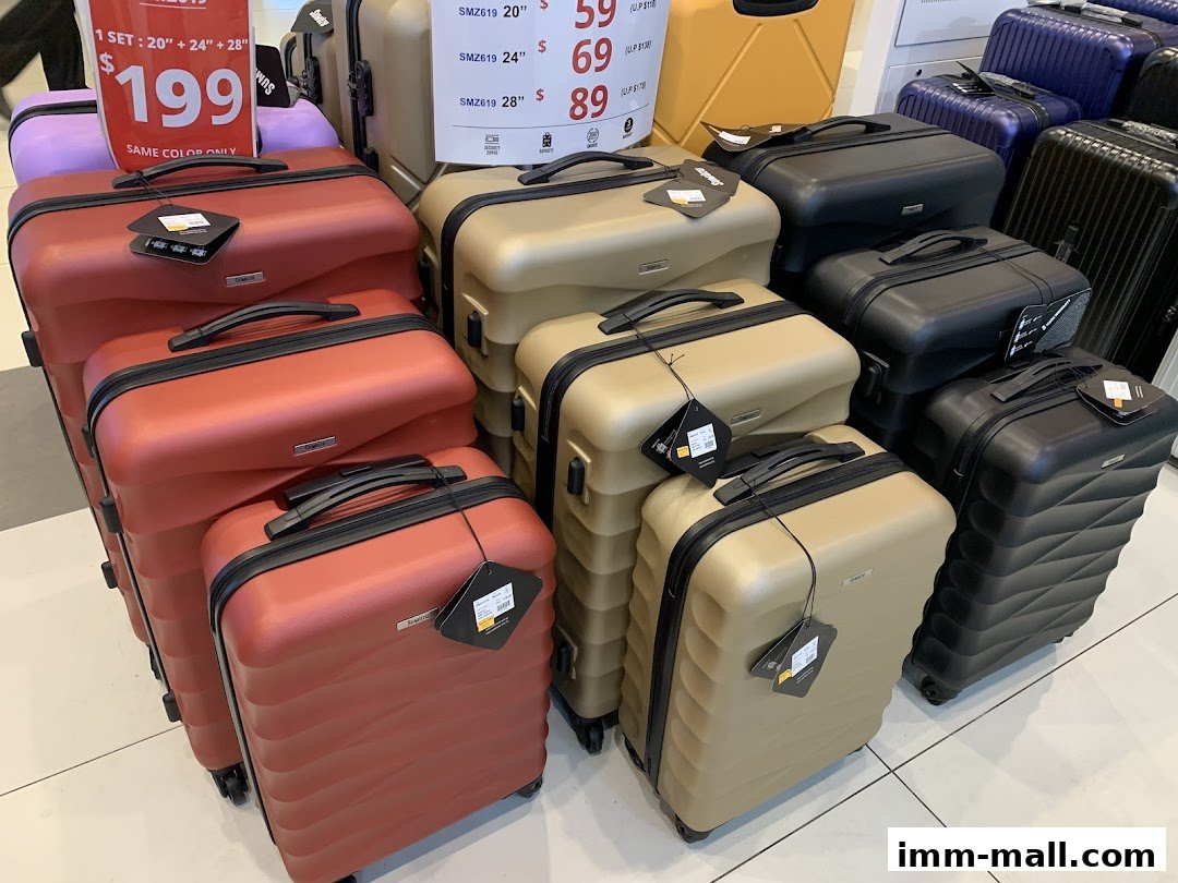 A display of various suitcases in different colors and sizes, with a promotional price tag.