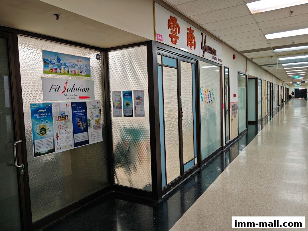A view of the Yunnan General Supplier shop front and adjacent units in a mall corridor.